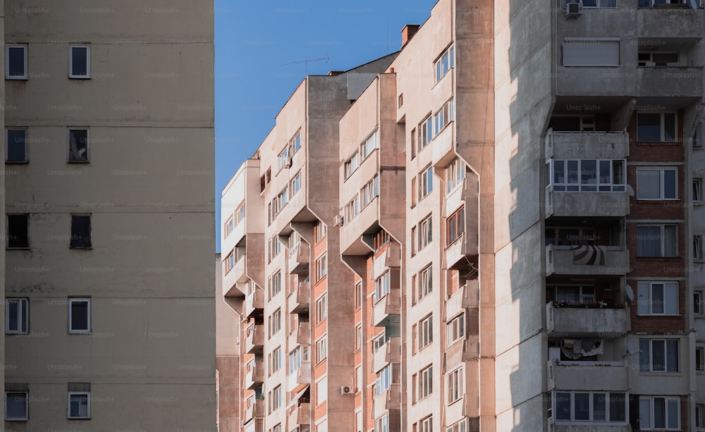 a tall building with many windows and balconies