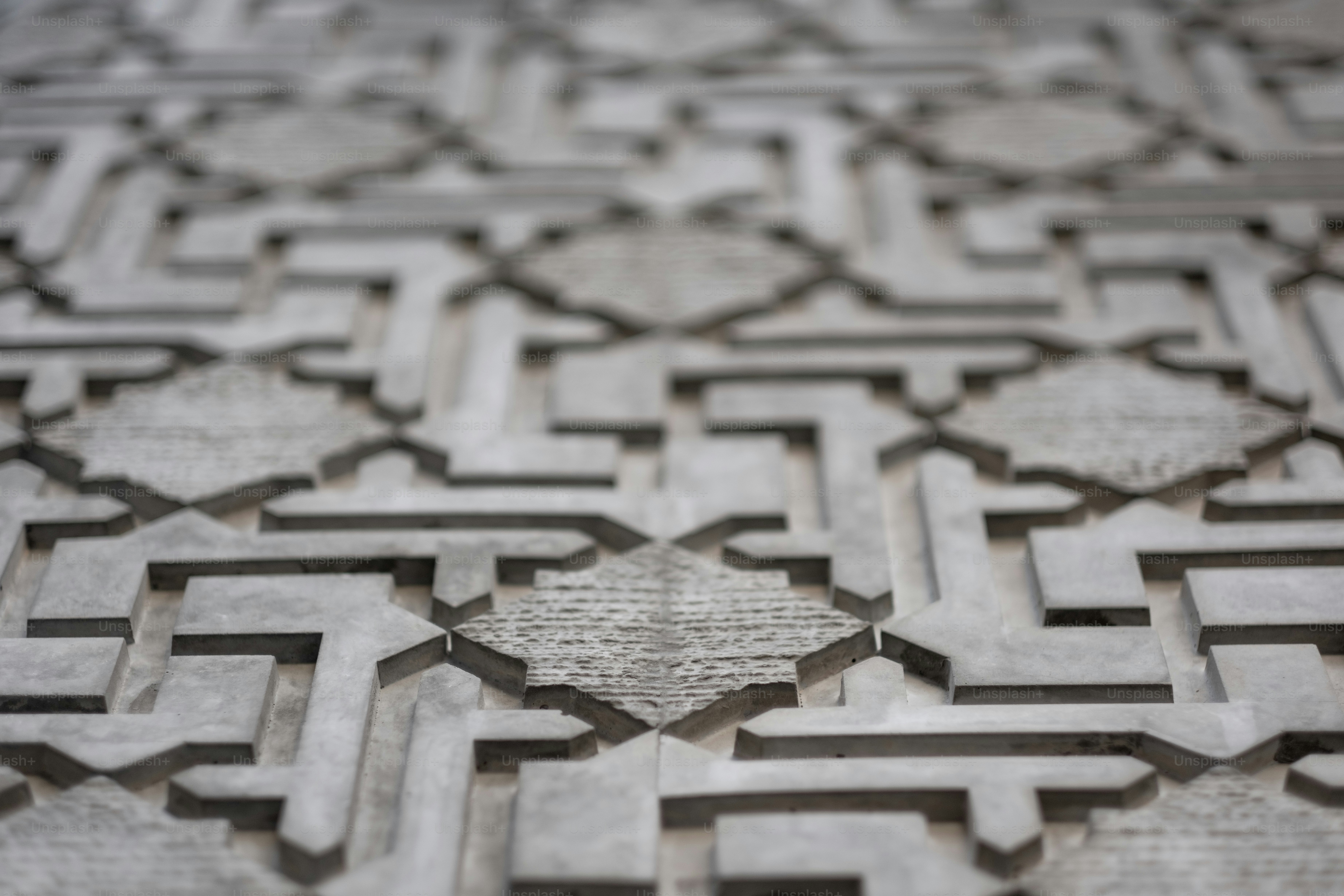 A geometric, Islamic-style pattern on the façade of a building.