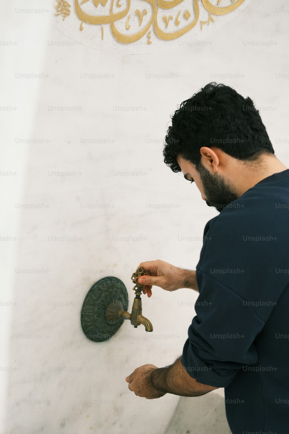 a man holding a key in front of a wall
