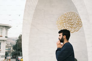 a man standing in front of a white building