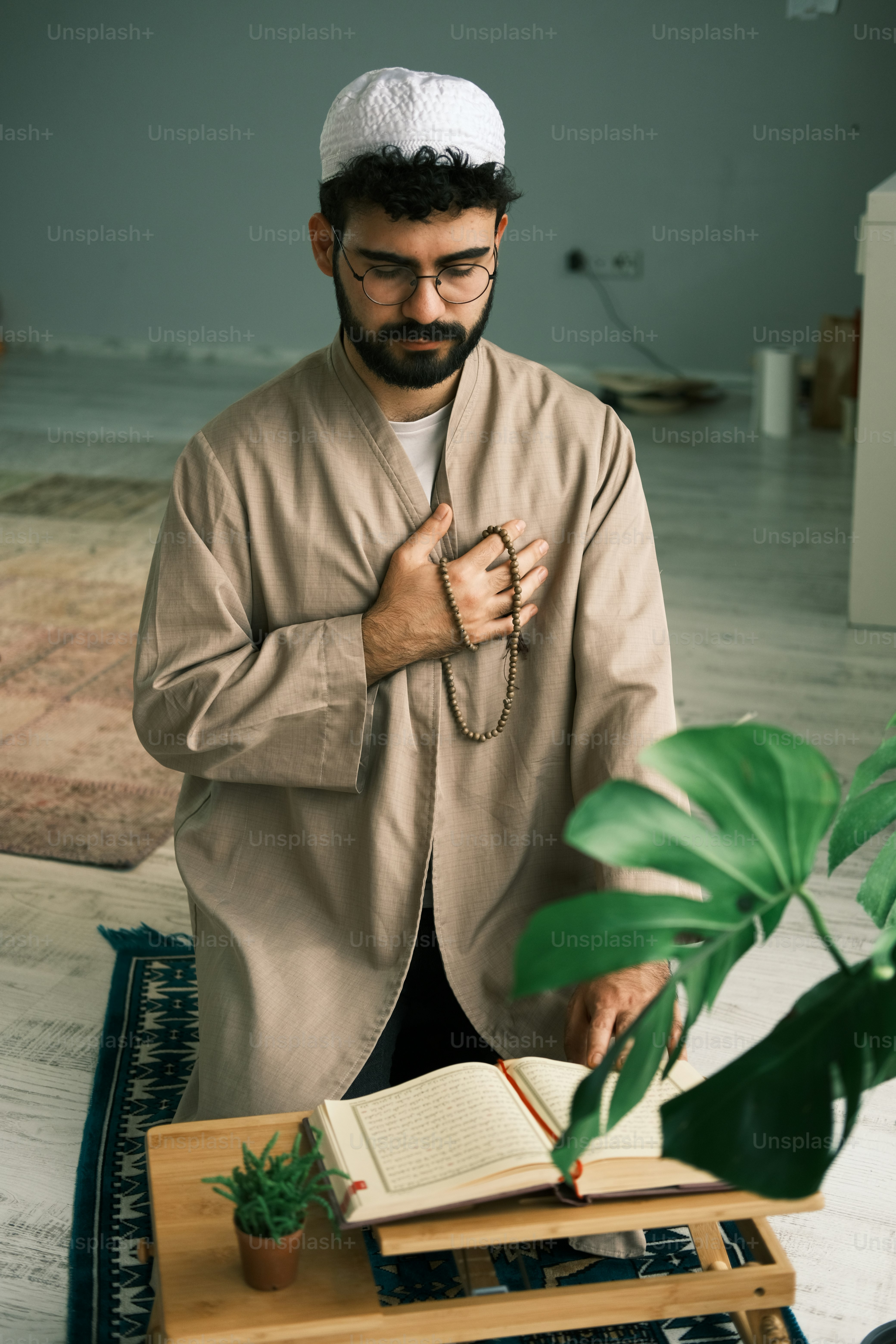 a man standing in front of a table with a book