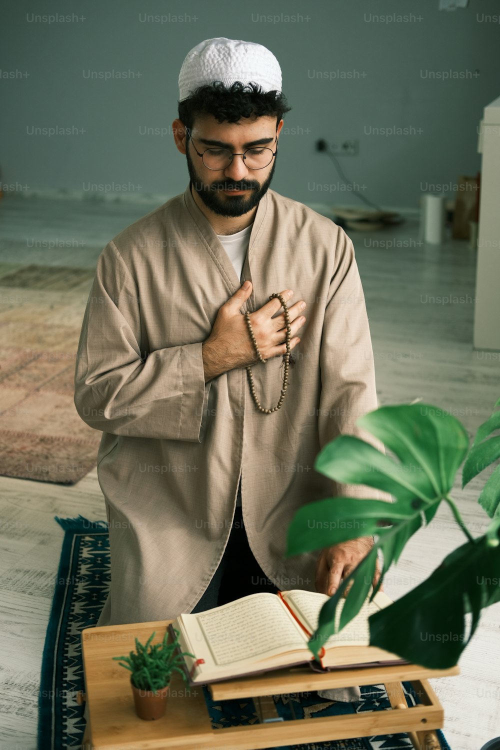 a man standing in front of a table with a book