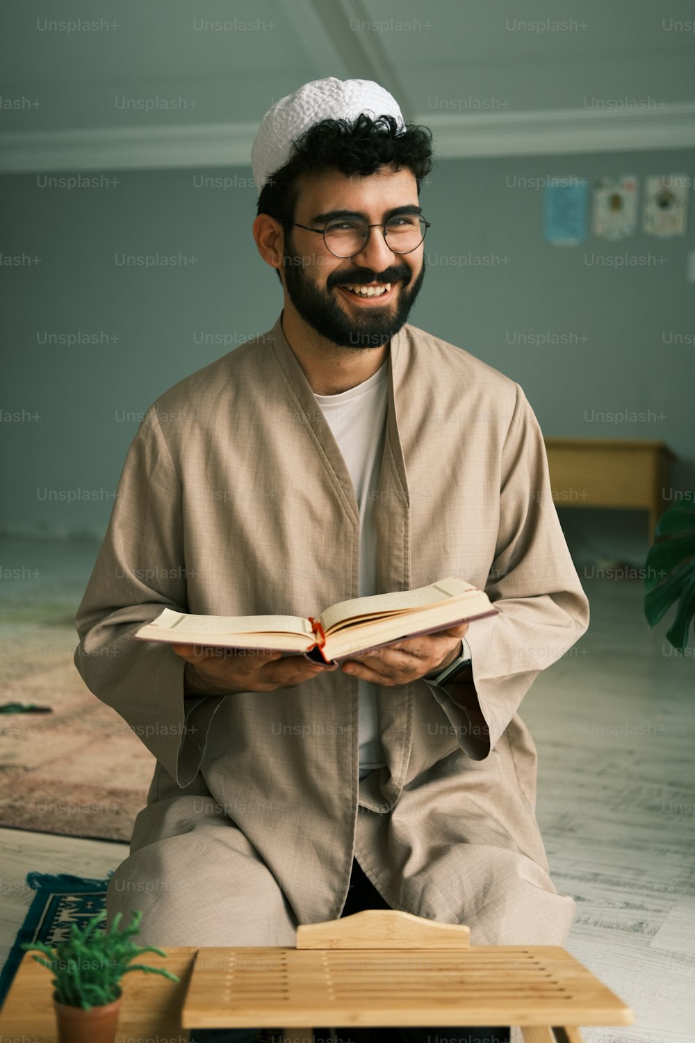 a man sitting on the floor reading a book