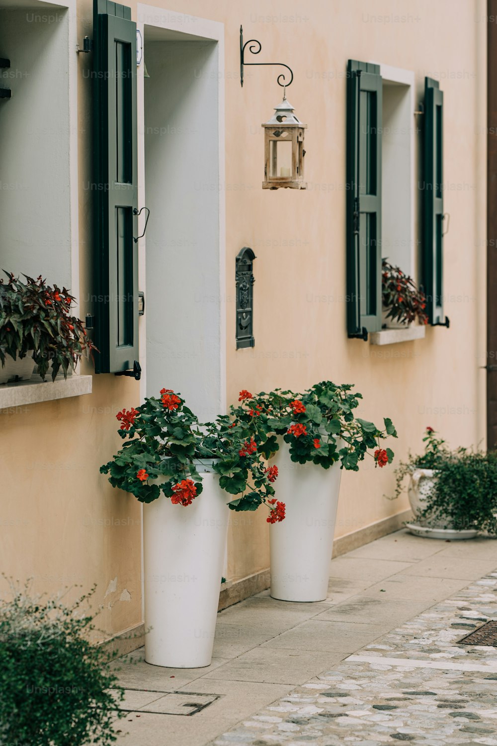 a couple of white planters sitting next to a building