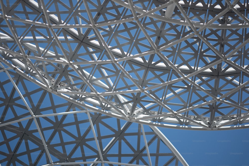 a close up of a metal structure with a blue sky in the background