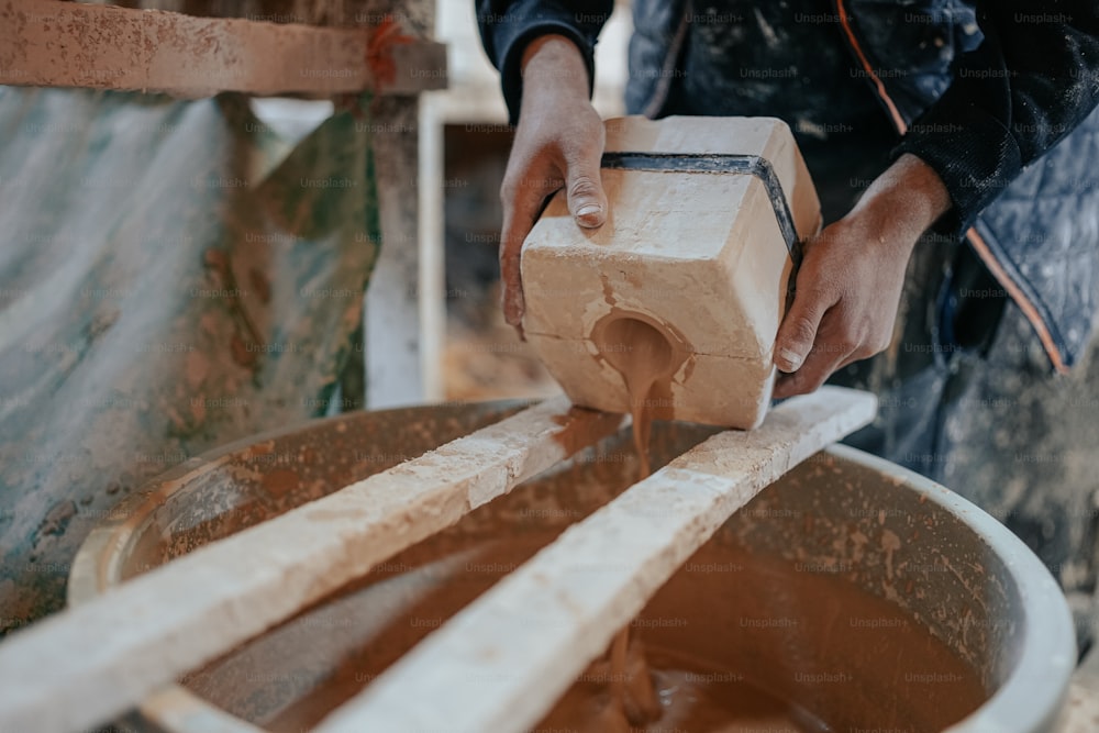 a person is making something out of clay