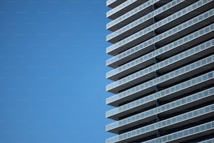 a very tall building next to a very blue sky