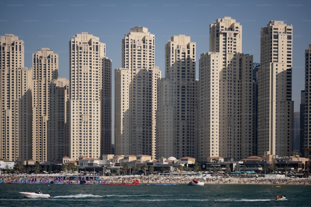 a large group of tall buildings next to a beach