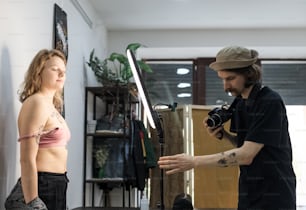 a man taking a picture of a woman with a camera