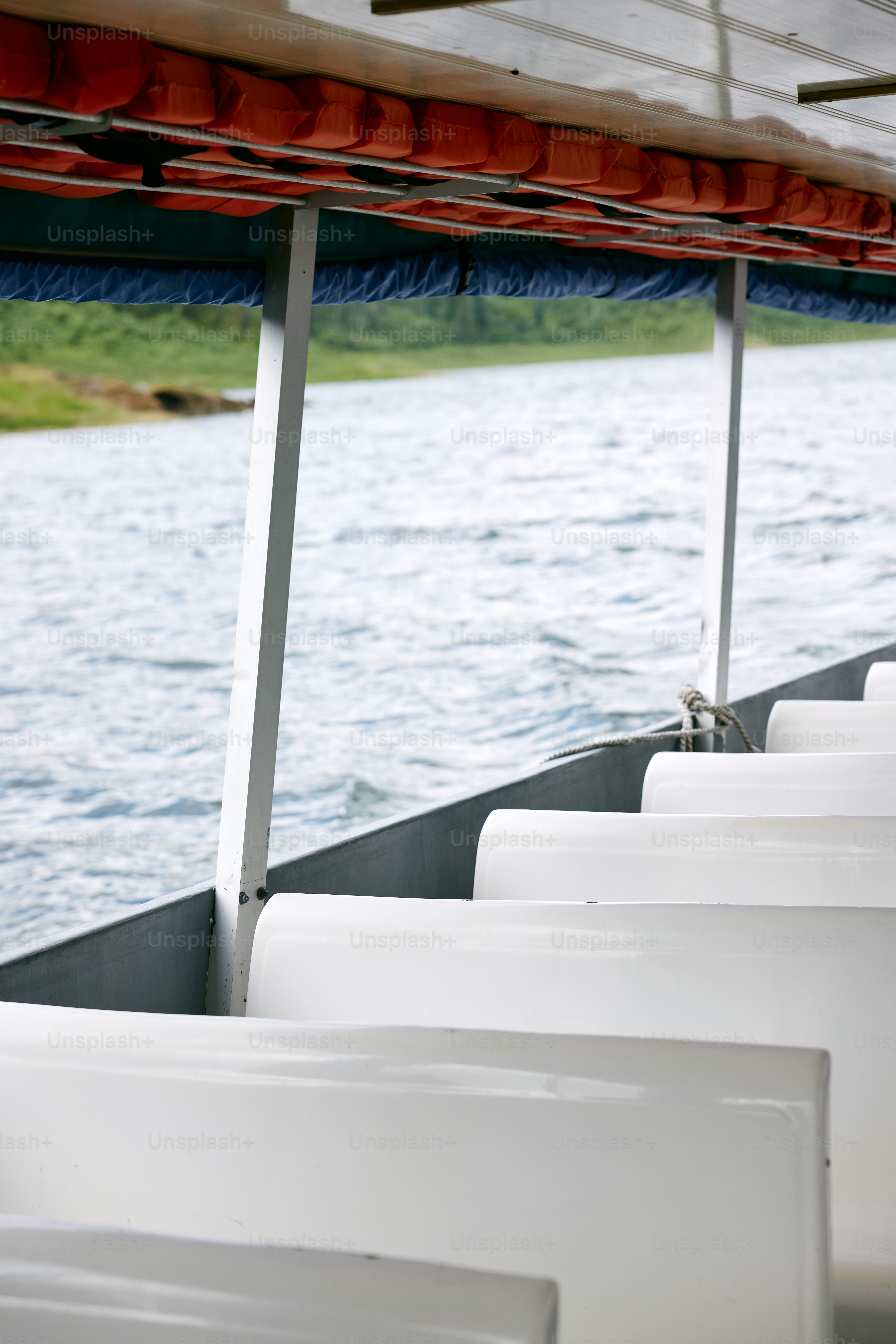 a row of seats sitting next to a body of water