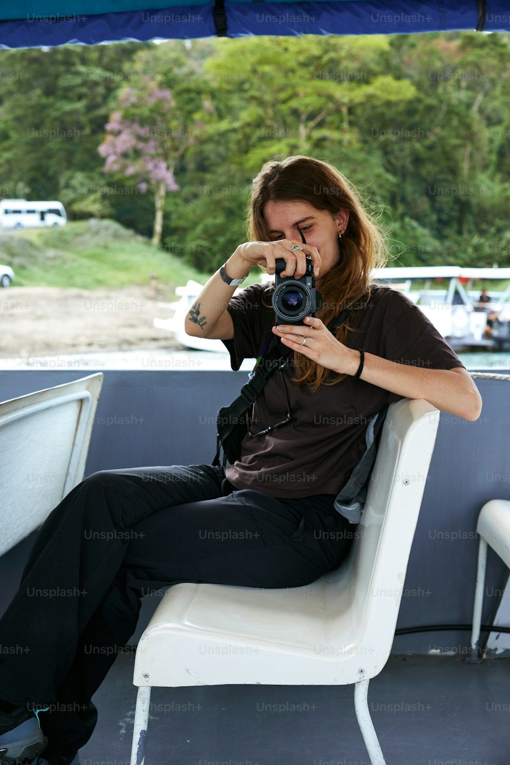 a woman sitting in a chair holding a camera