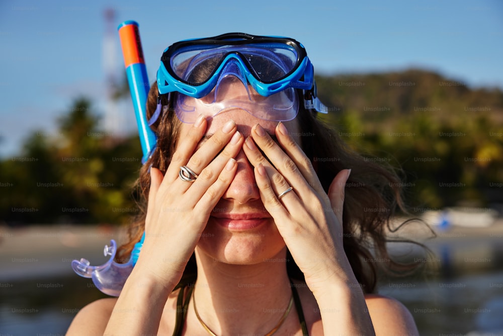 a woman with goggles and snorkels covering her eyes