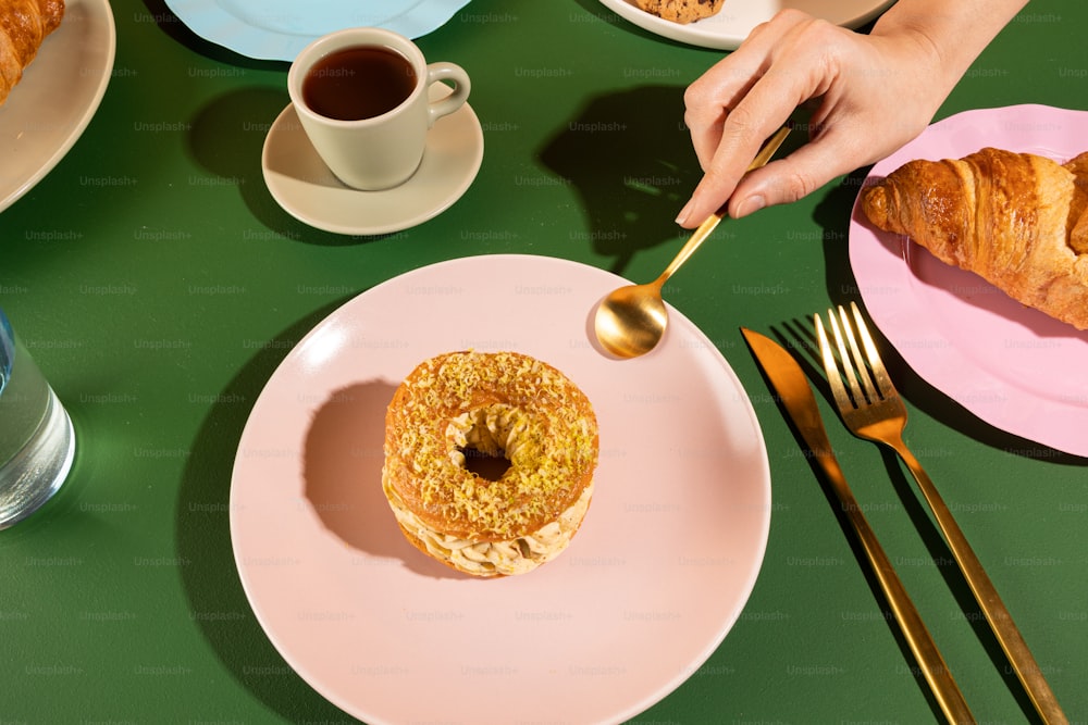 a person is spooning a doughnut on a plate