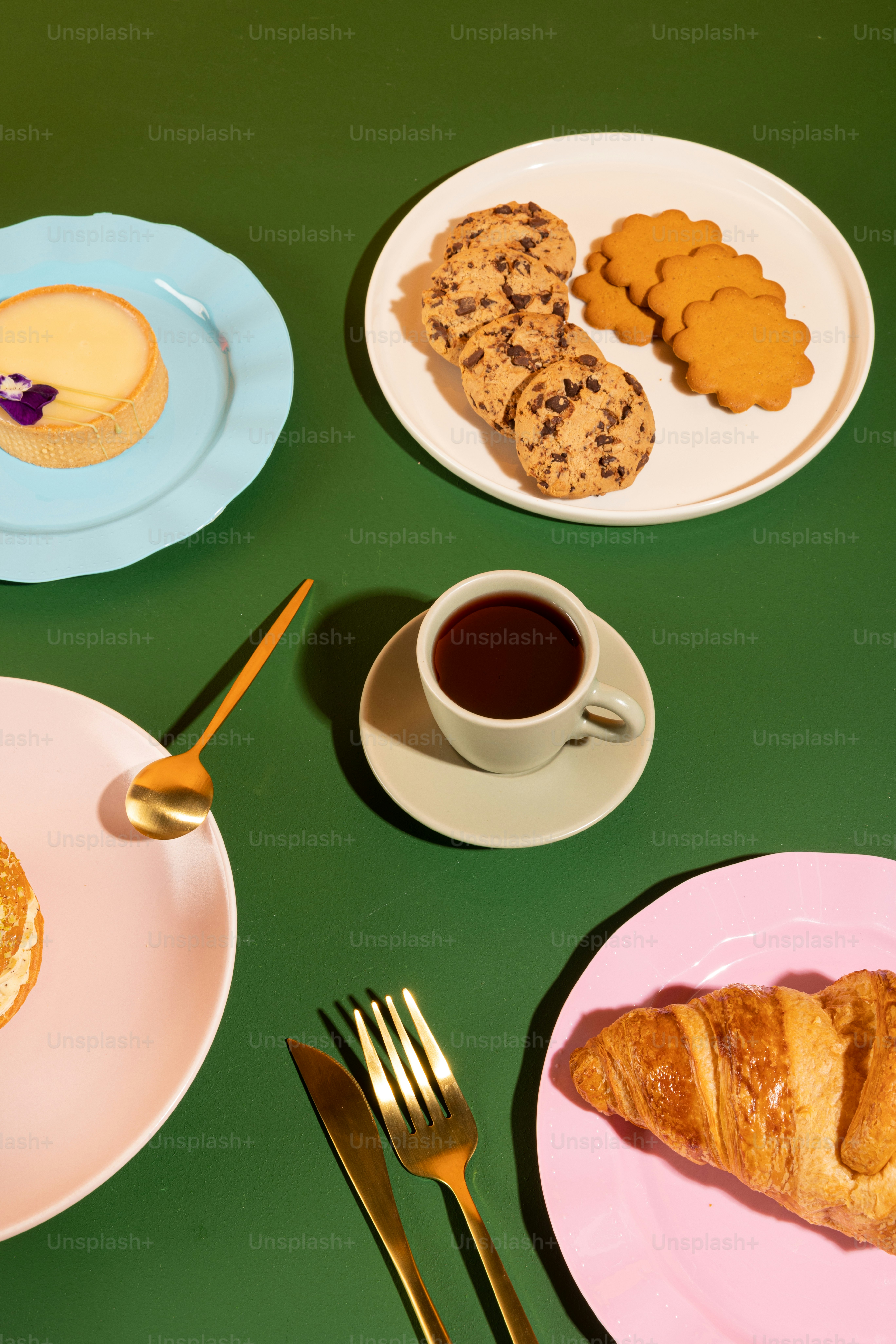 a table topped with plates of food and a cup of coffee