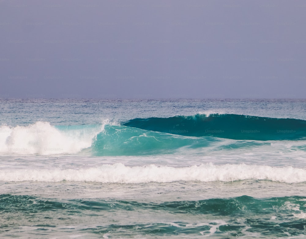 a person riding a wave on top of a surfboard