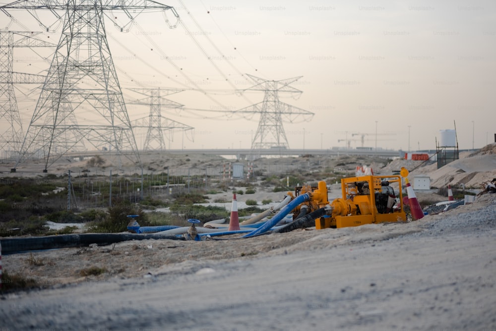 a construction site with a large power line in the background