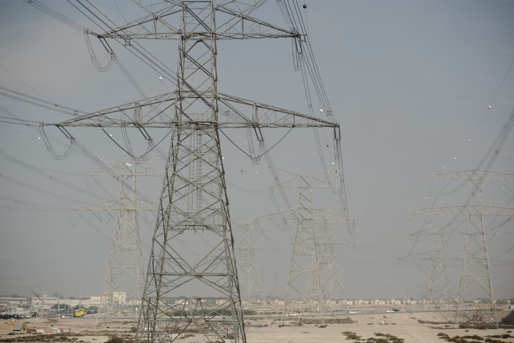 a group of power lines in the middle of a desert