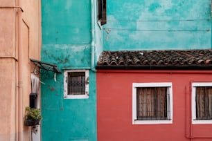 a red and blue building next to a green building