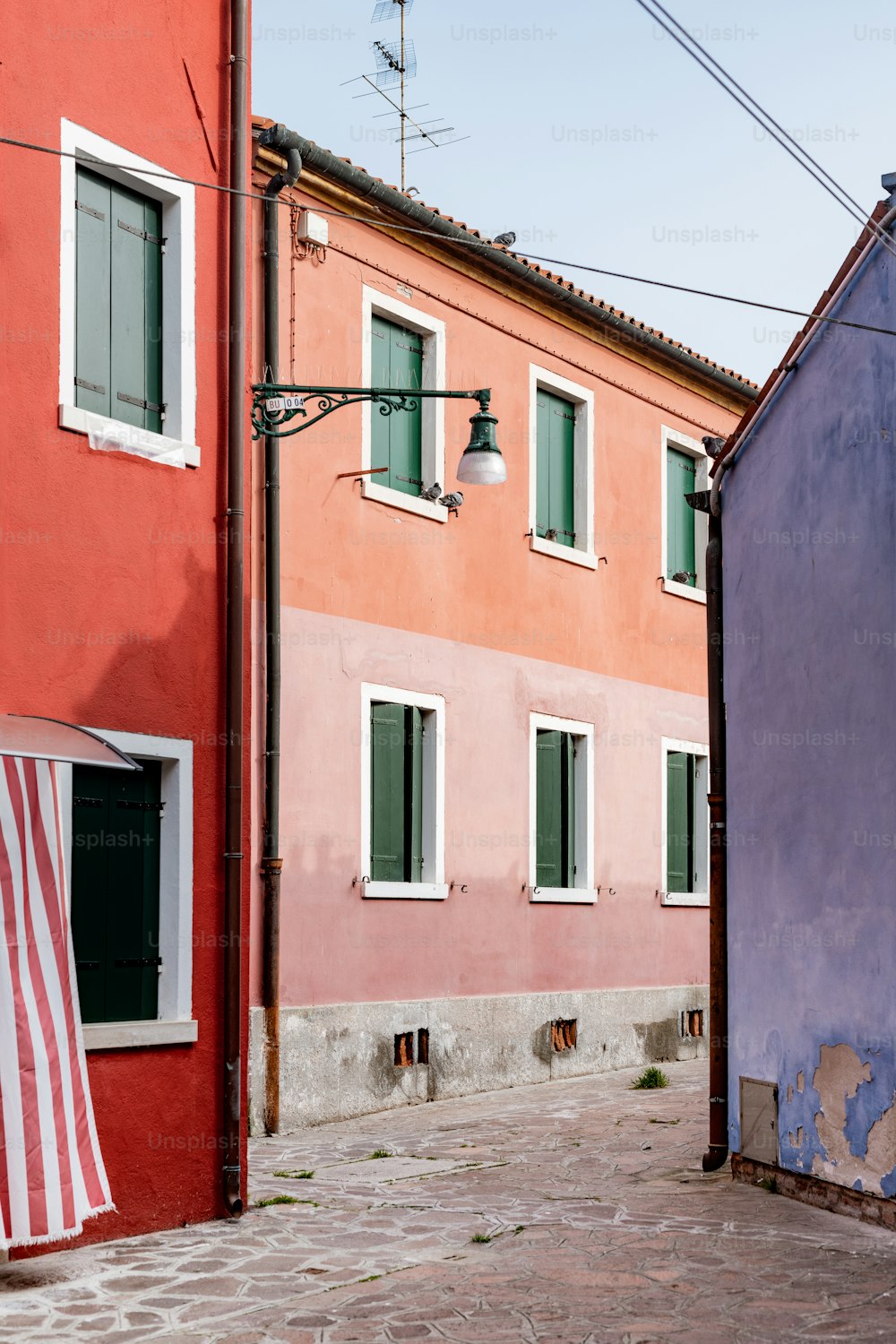 a red and pink building next to a blue building