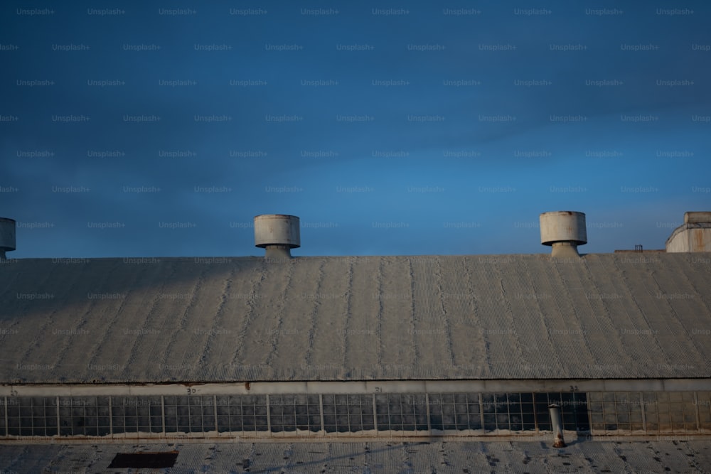the roof of a building with three water tanks on top