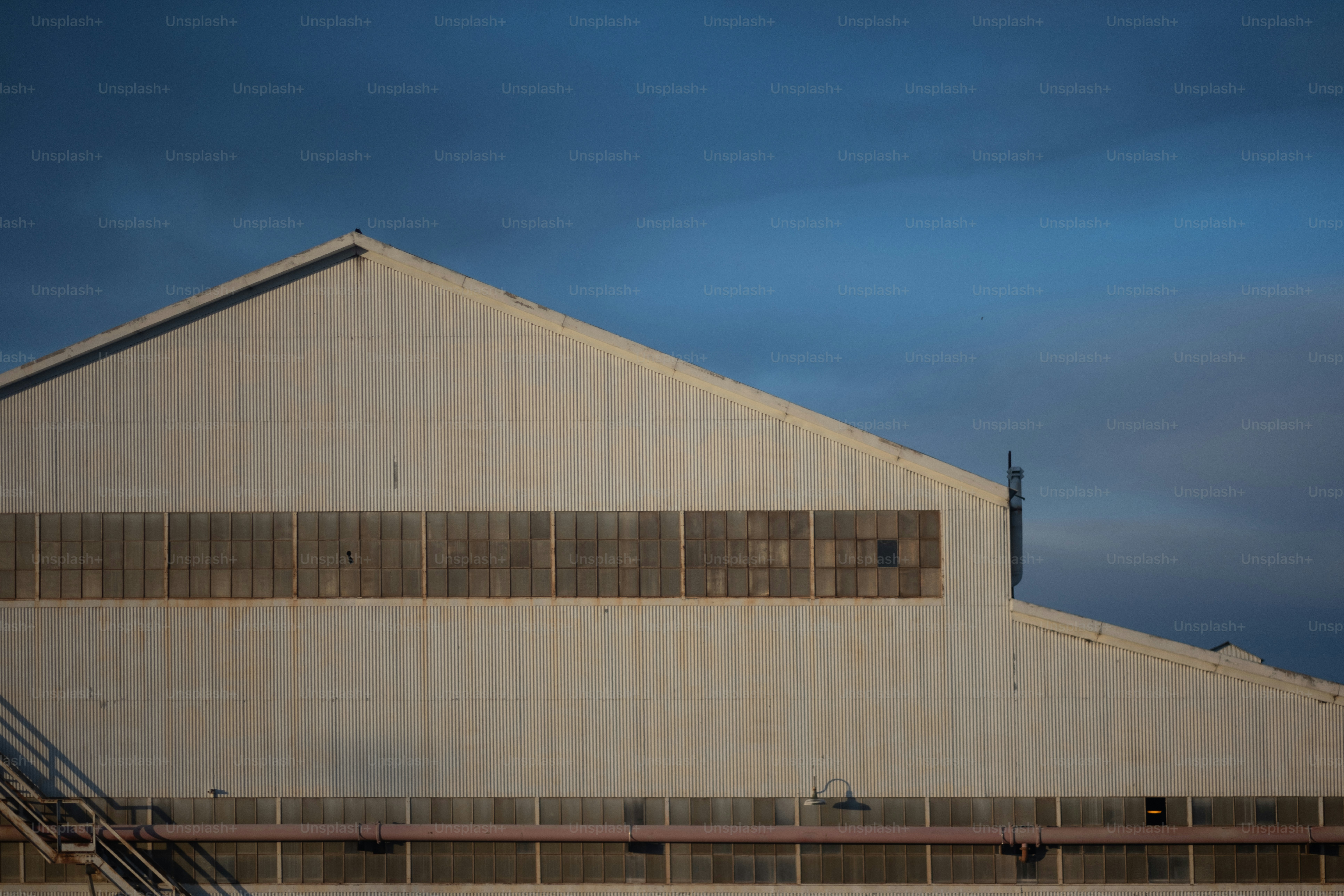 an airplane is flying over a large building