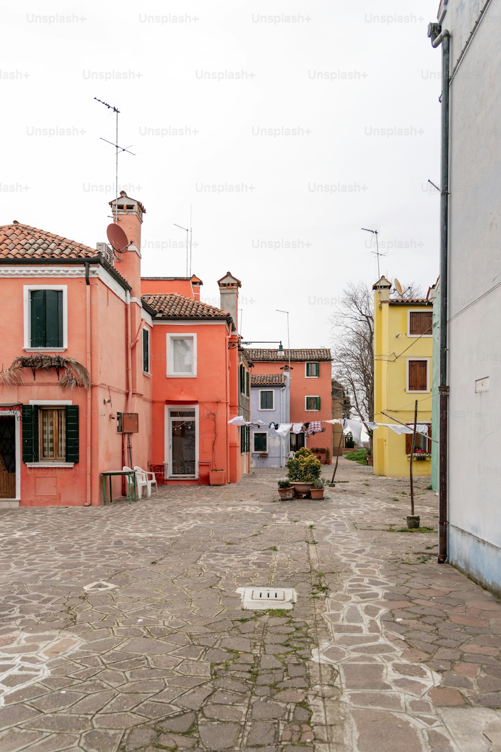 a cobblestone street lined with colorful buildings