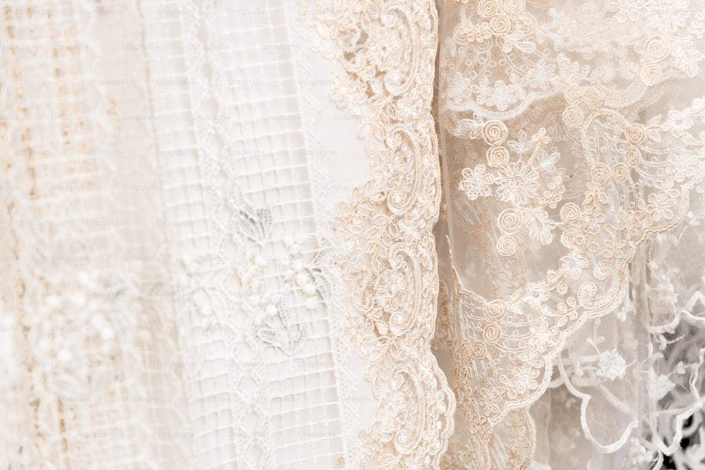 a close up of a white lace dress
