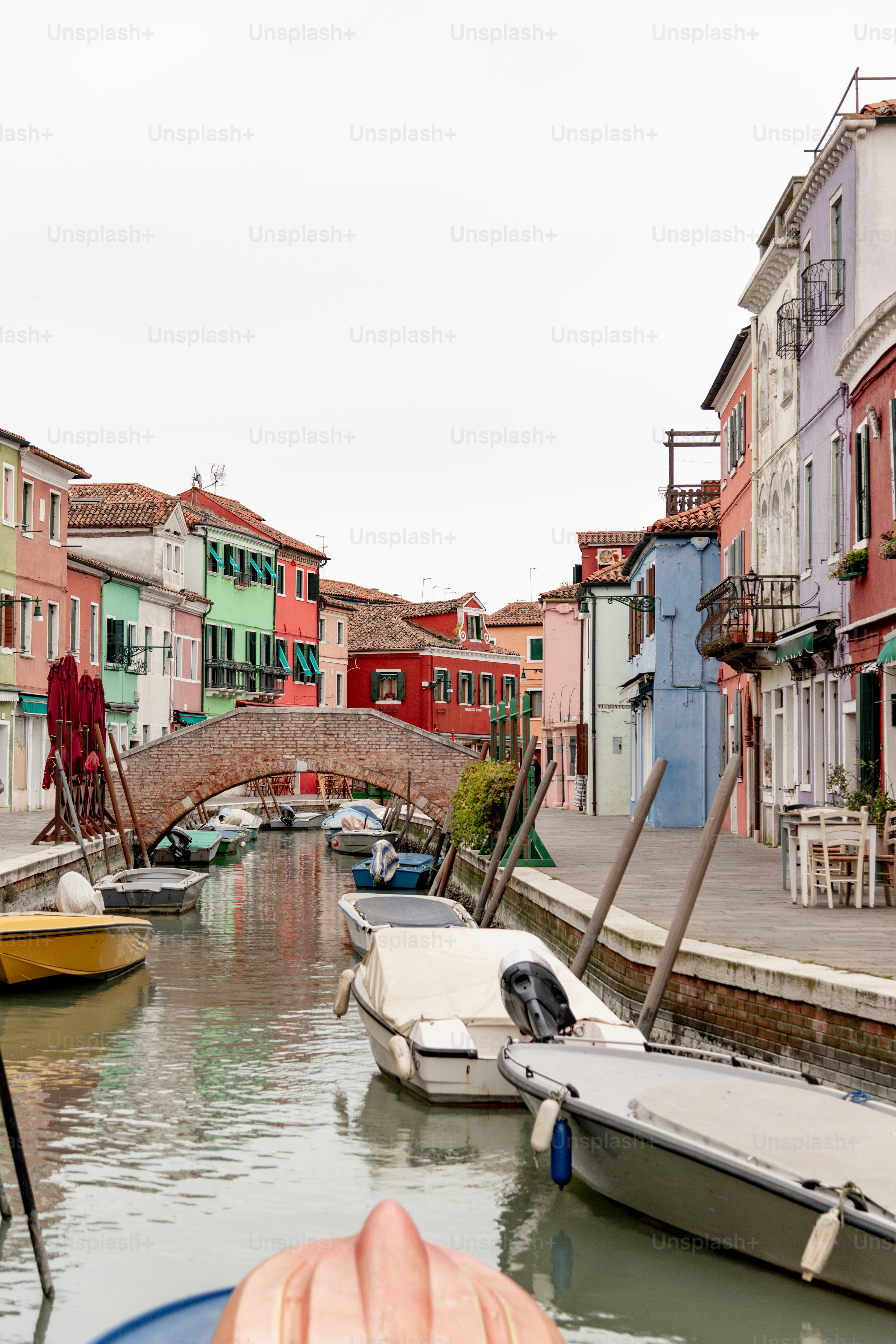 a person's hand on a boat in a canal
