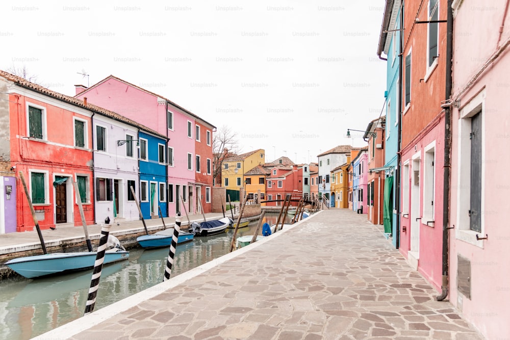 a row of colorful houses along a canal