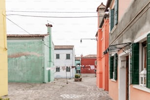 a cobblestone street lined with colorful buildings