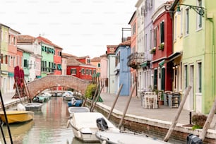 a canal with boats and a bridge in the background