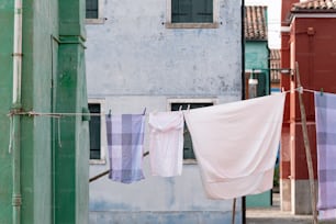 clothes hanging on a clothes line in front of a building