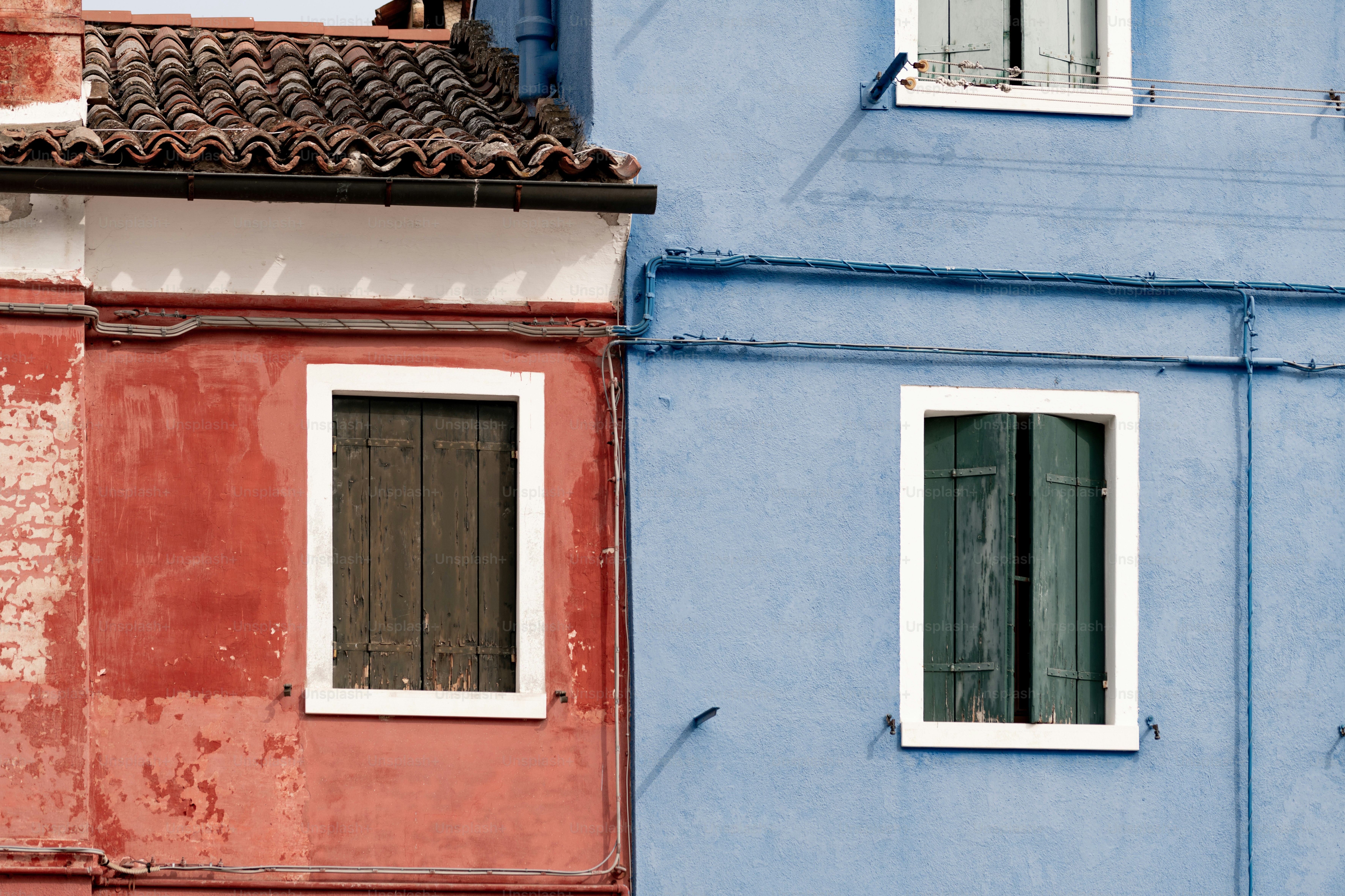 a blue building with a red building next to it