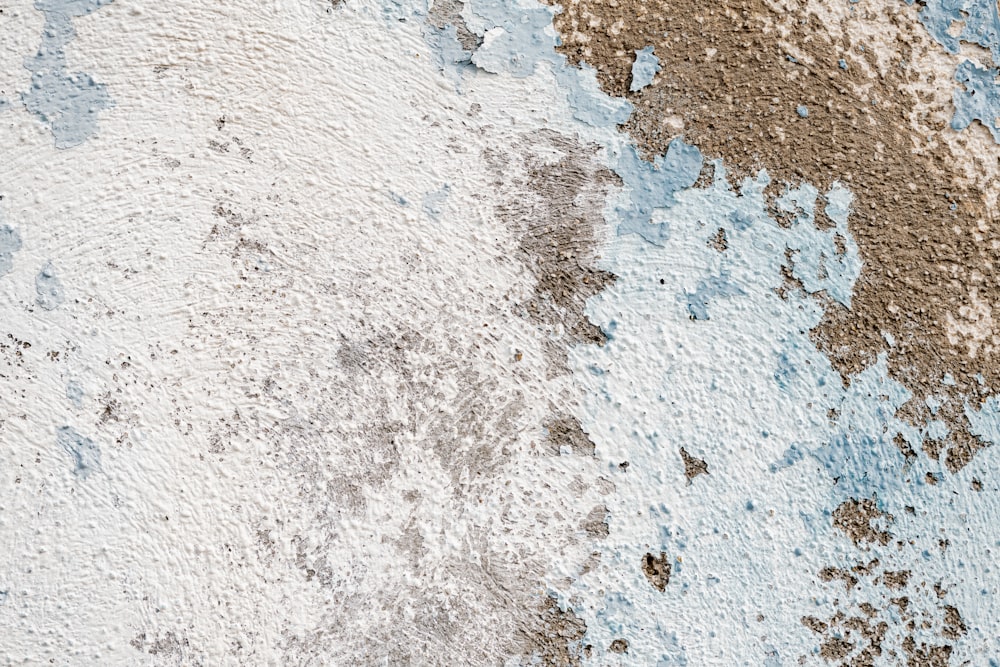 a close up of a wall with blue and brown paint