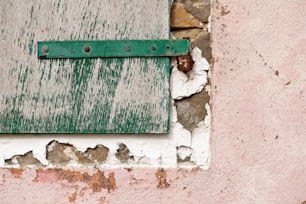 a close up of a green and white window on a wall