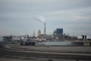 a factory with smoke coming out of it's stacks