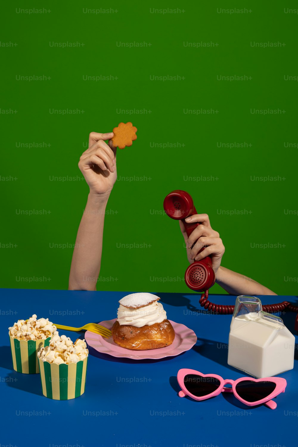 a person holding a cookie in front of a green screen