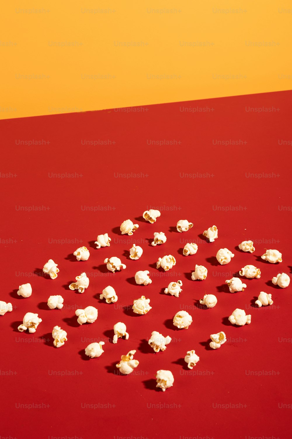 a red table topped with lots of white marshmallows