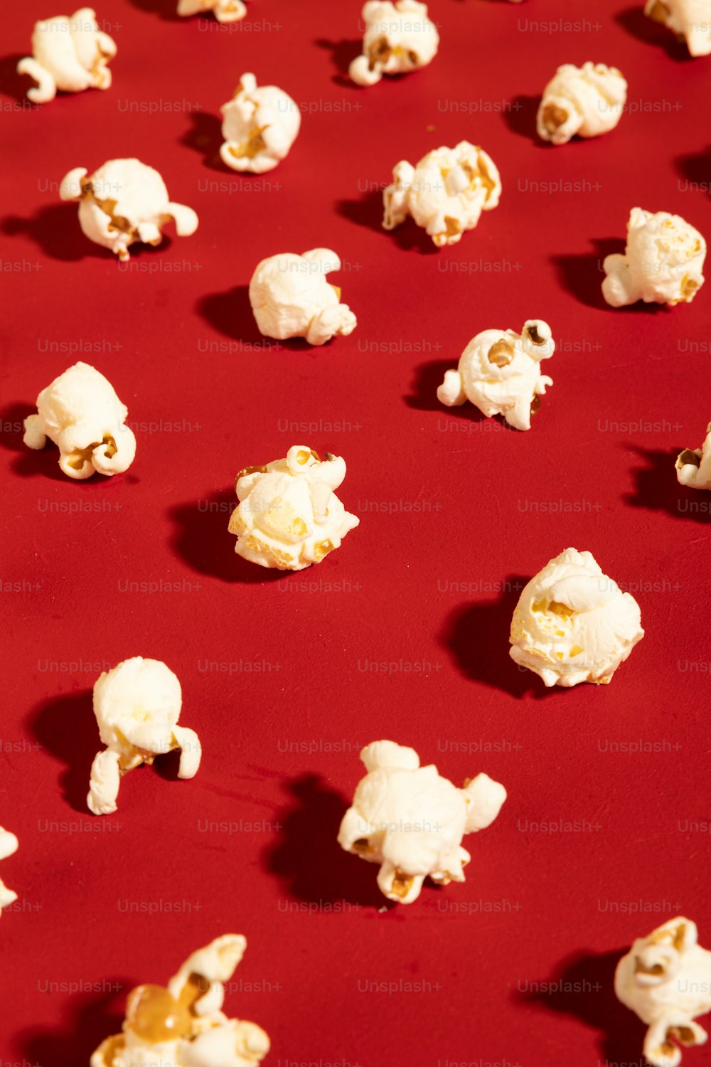 a red table topped with lots of popcorn