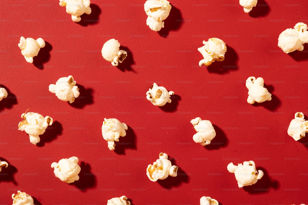 a bunch of popcorn sitting on top of a red table