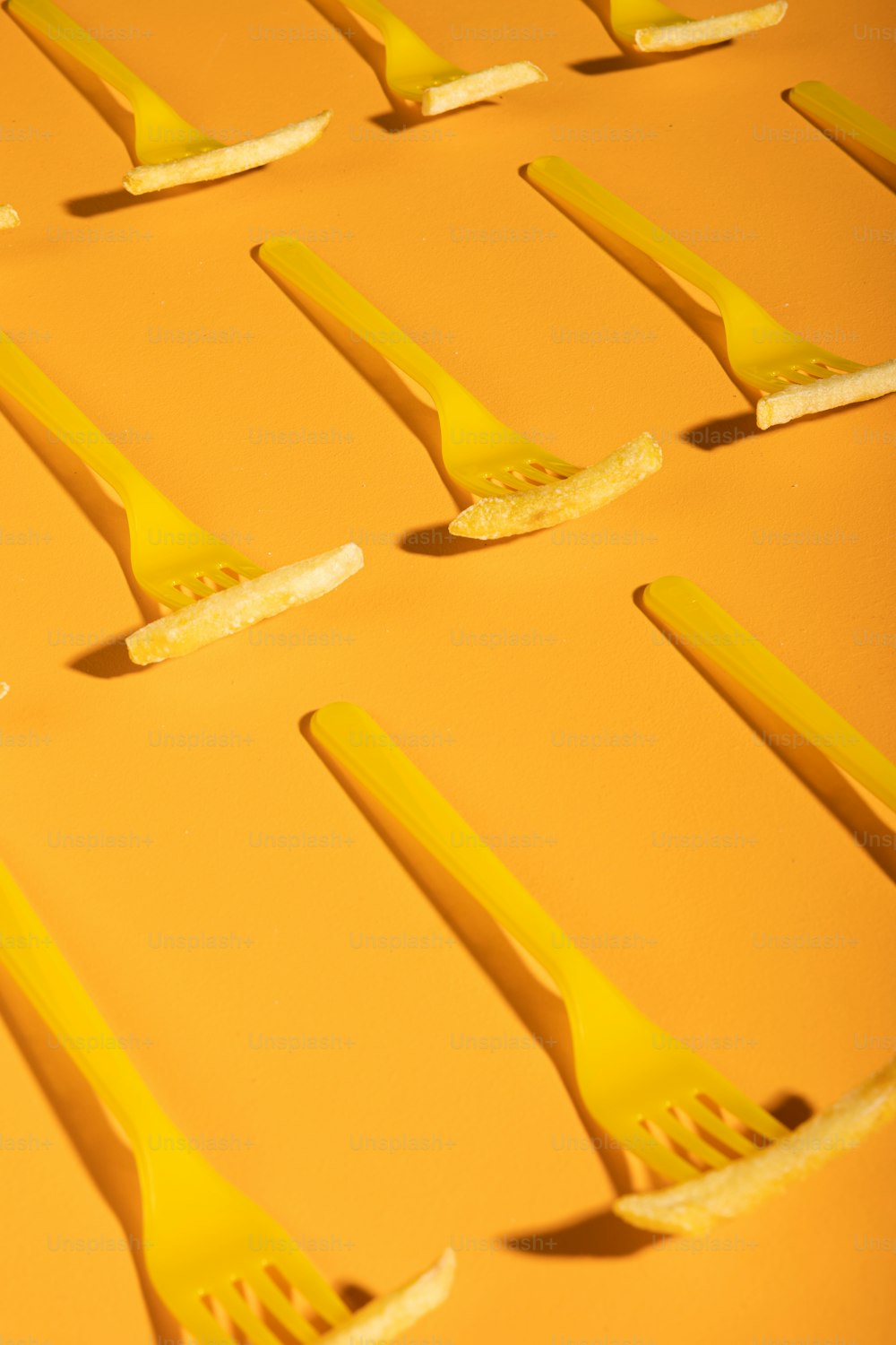 a group of yellow toothbrushes laying on top of each other