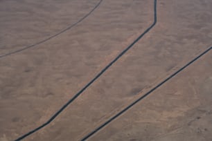 an aerial view of a road in the middle of the desert