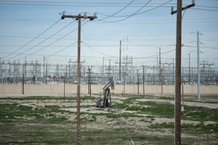 a field with lots of power lines and telephone poles