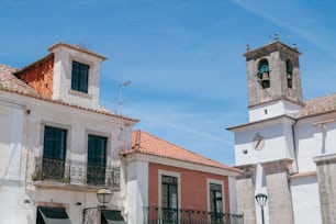 a couple of buildings with a clock tower in the background