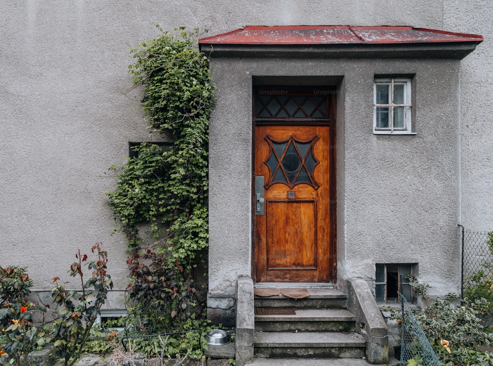 a house with a wooden door and steps leading up to it