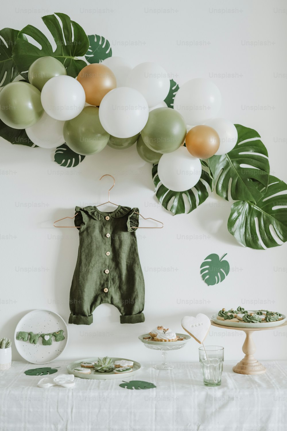 녹색과 흰색 풍선이 있는 아기의 첫 생일 파티