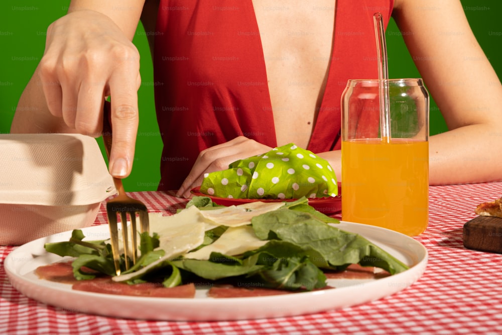 a woman sitting at a table with a plate of food