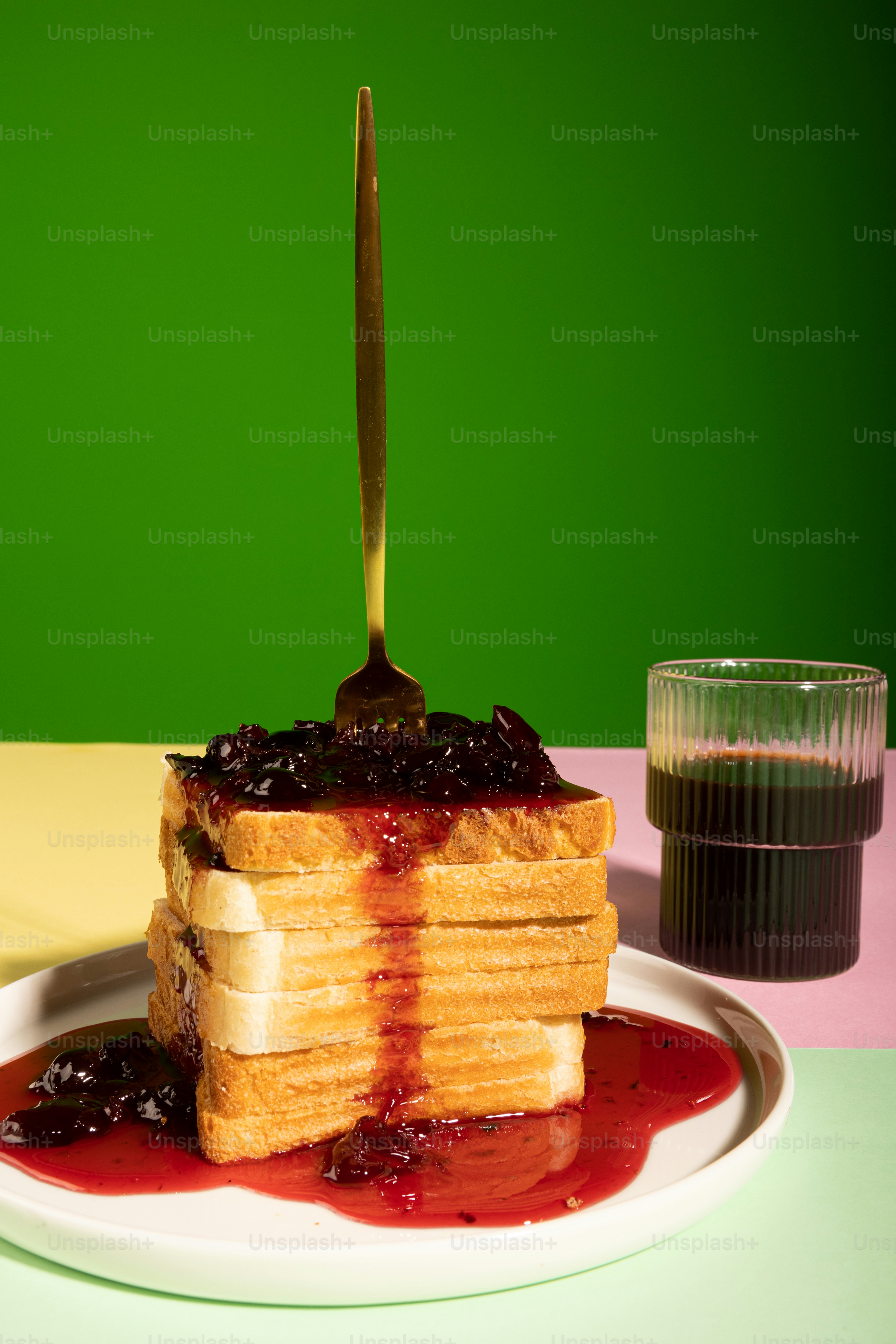a white plate topped with a stack of pancakes covered in syrup