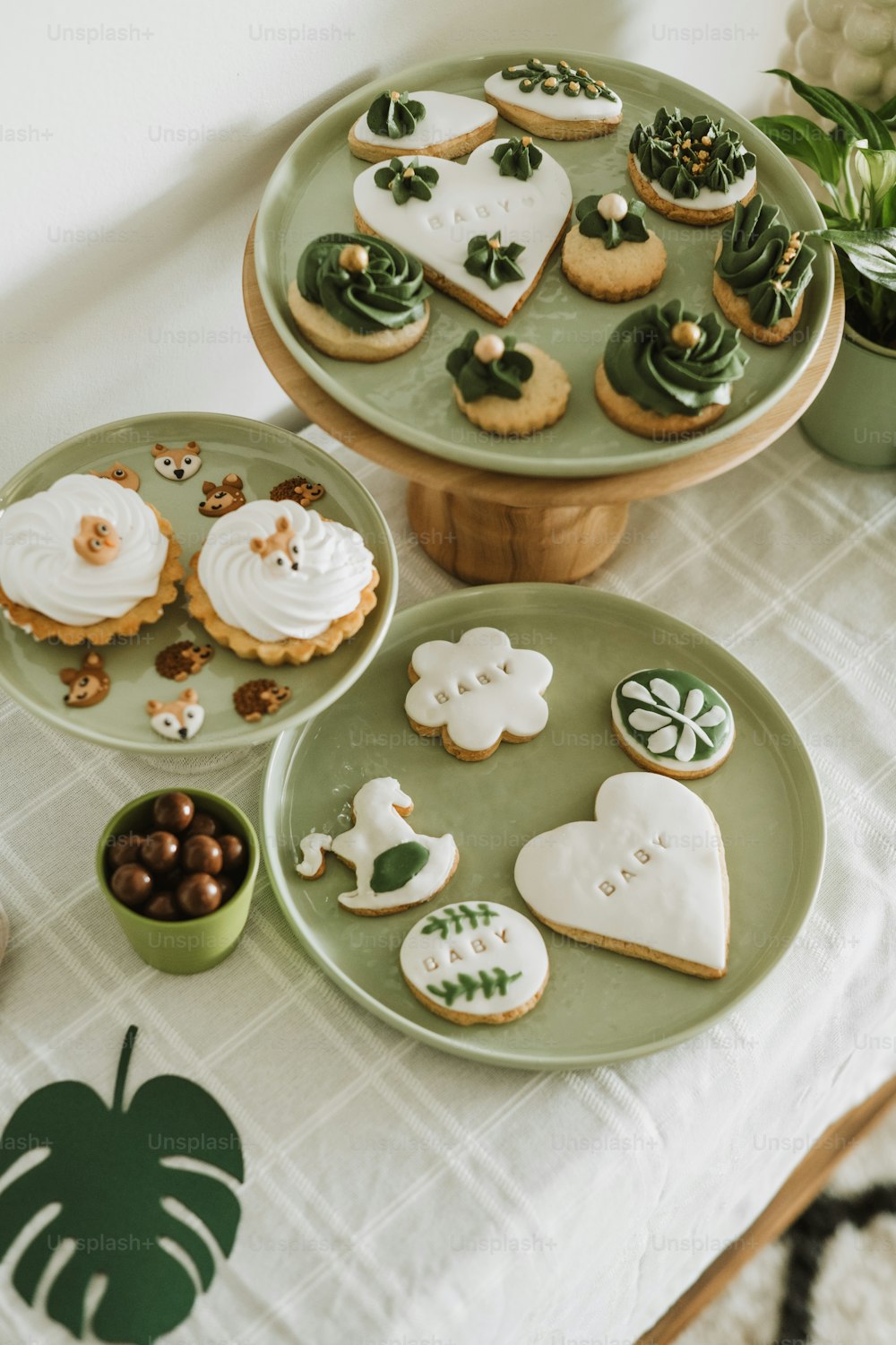 a table topped with green plates filled with cookies