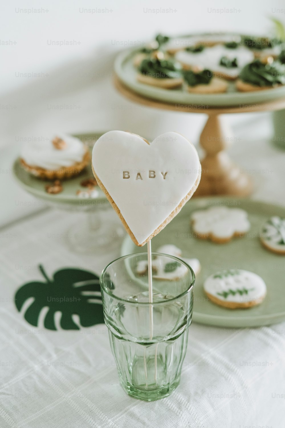 a baby cookie on a stick in a glass